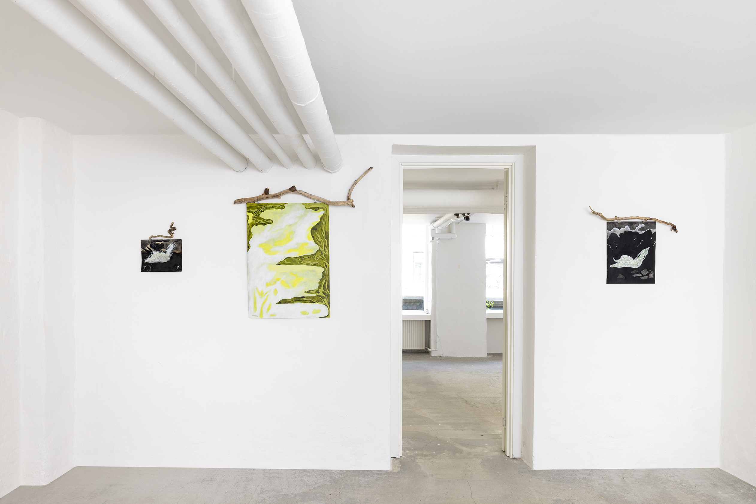 Paintings, each decorated with a expressive stick in a white room
